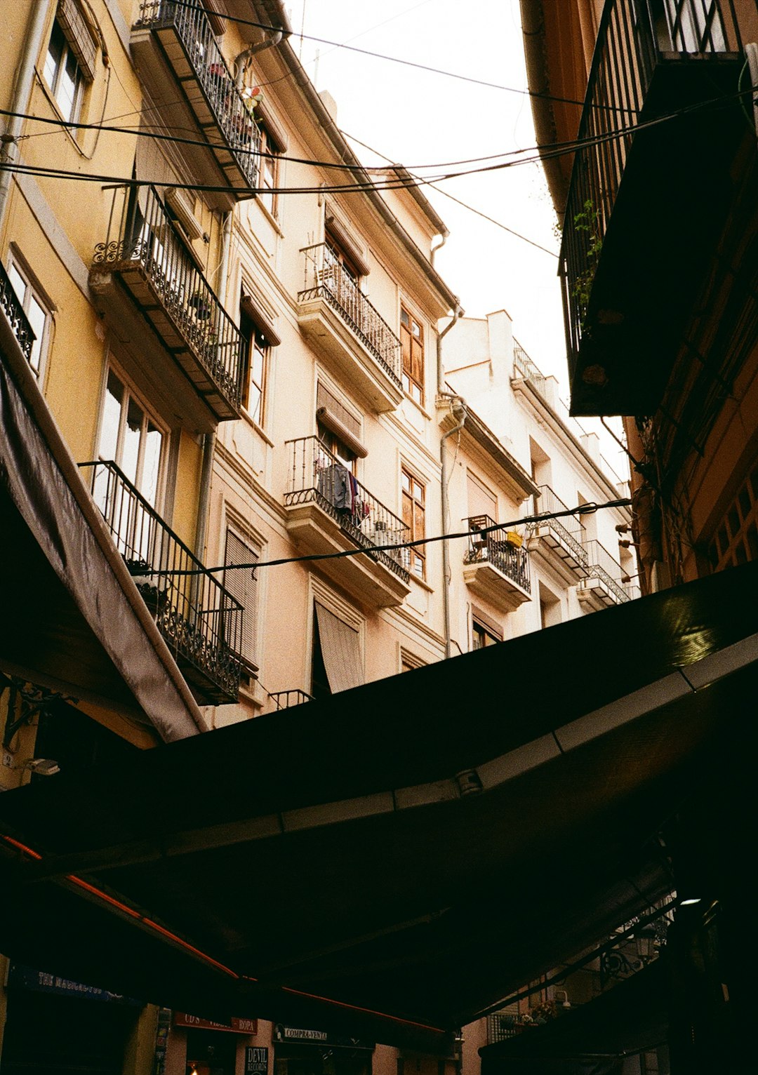 Photo by Richard Stachmann Buildings with balconies line a narrow european street.